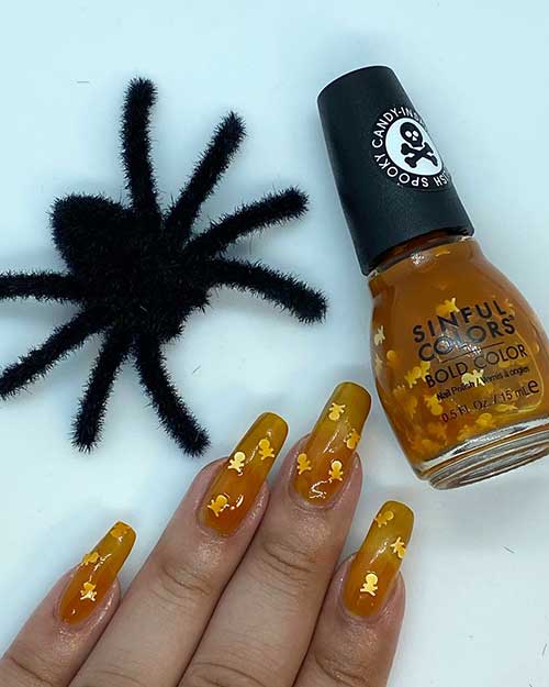 Elegant long Halloween nails featuring SinfulColors Twisted Toffee polish, perfect for celebrating the spooky season.