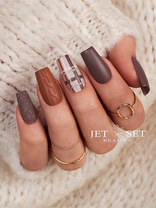 Cozy autumn-inspired nail design with plaid, textured sweater patterns, and glitter accents for a stylish seasonal look.