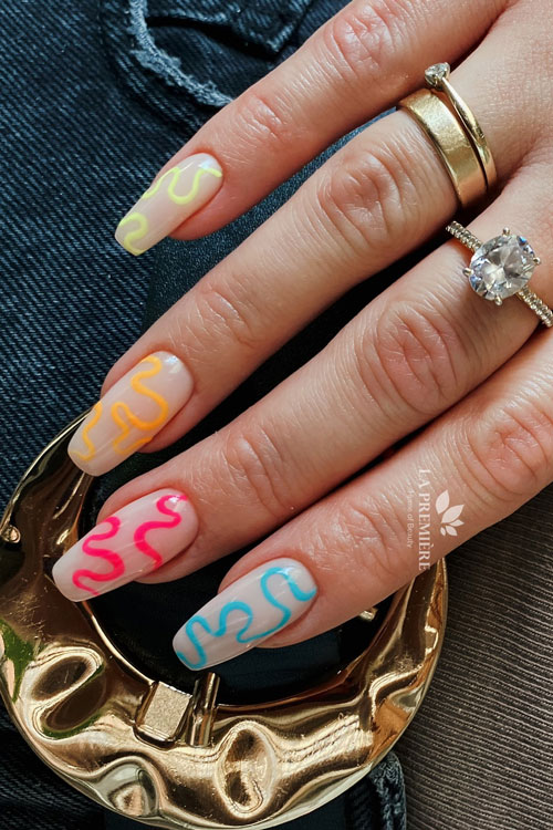 Cute colorful swirl nails coffin shaped over a nude base color
