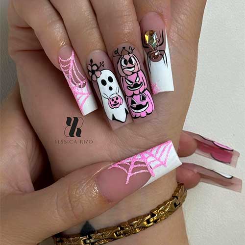 Long square white French Halloween nails featuring pink glitter spider web, rhinestone spider, pumpkin, and ghost art.