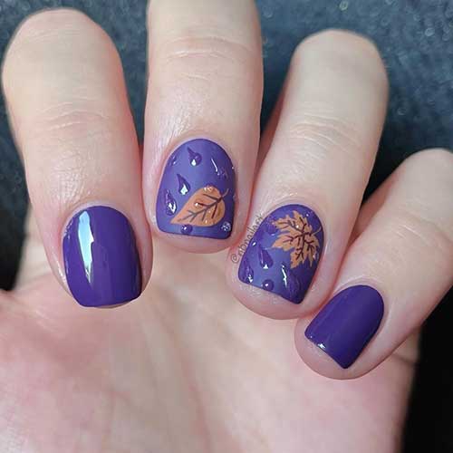 Short purple fall nails featuring water drop art and maple leaves on two accent nails, showcasing autumn elegance.