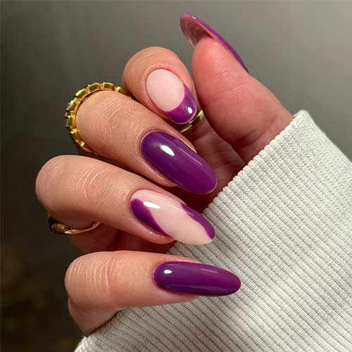 Elegant dark purple nails featuring a French accent and a negative space accent nail for a chic look.