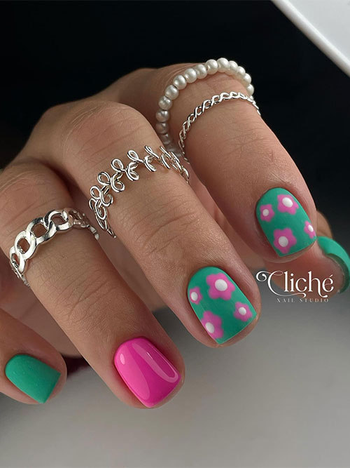 Matte green and pink spring nail design features matte green nails two of them adorned with pink flowers