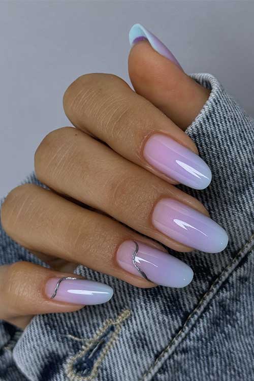 Long almond shaped pastel summer ombre nails feature pink, purple to light blue ombre style