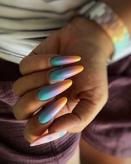 Long almond turquoise purple orange summer ombre nails with a thumb nail adorned with colorful dots and white speckles