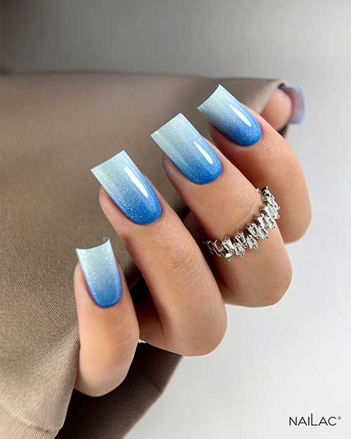 Long square shaped dark to light blue summer ombre nails with glitter