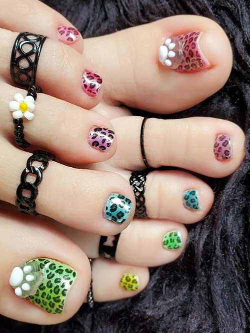 Multicolored chrome toenails in green, blue, purple, red, and pink nail colors decorated with black leopard prints