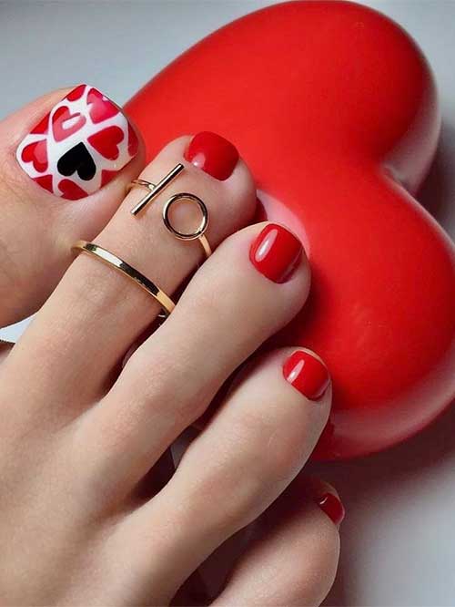 Valentine's red toenails with a big toenail decorated with red hearts and a single black heart over a white base color