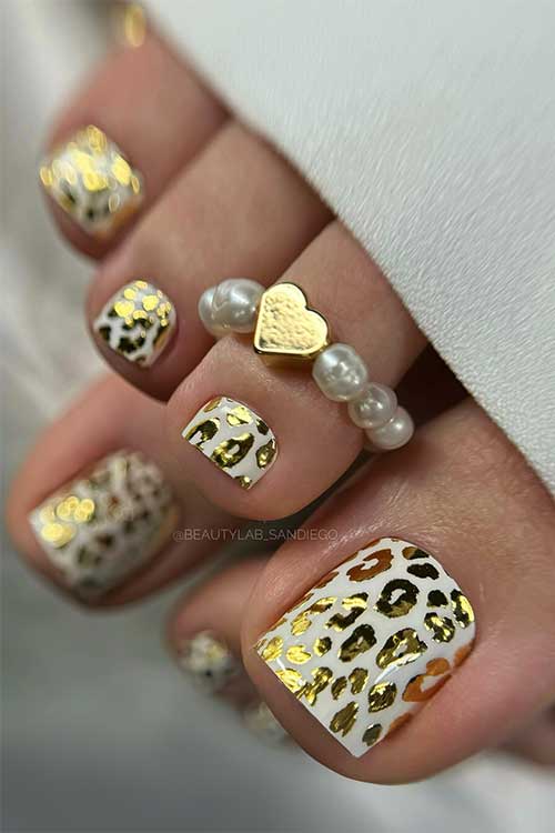 White pedicure wraps decorated with gold leopard prints