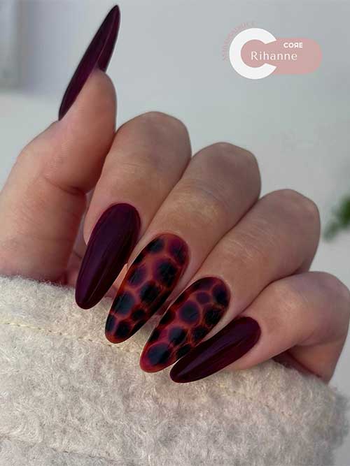 Almond-shaped matte brown nails complemented by two tortoise shell accent nails.