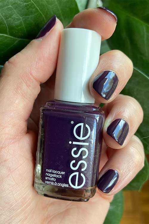 Eggplant purple nails painted with Essie Leather Weather from the Fall 2024 Punk at Heart Collection.