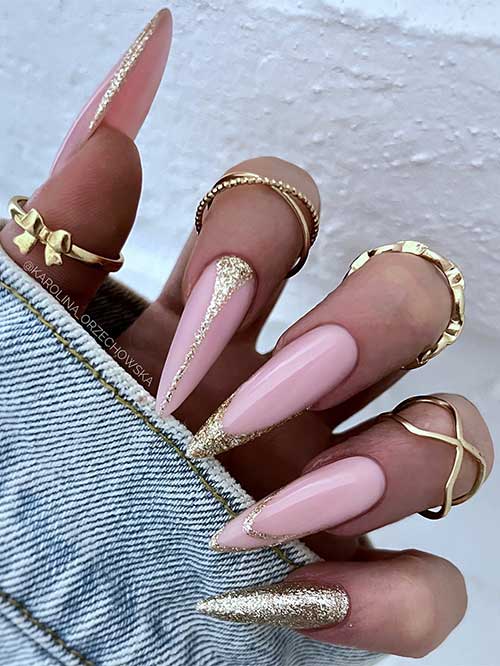 Gold glitter sparkling French nails with an accent nail adorned with line nail art and negative space French accent nail