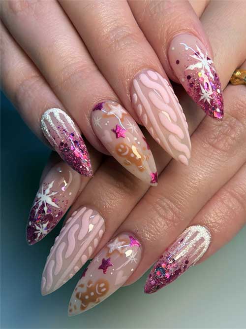 Cute almond-shaped Christmas nails with pink glitter tips, icicle art, and gingerbread, star, and heart designs on nude base.