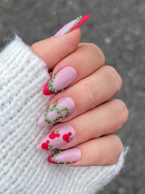 Matte red French Christmas nails adorned with wreath art and gold rhinestones resembling holly berries for a festive look.