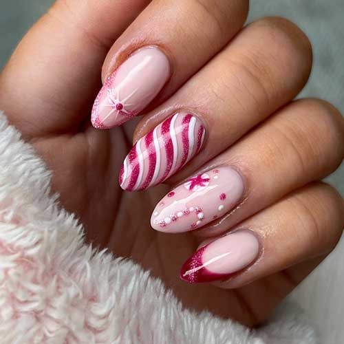 Red Christmas nails with French accents, candy cane designs, and glitter are the best Christmas nail ideas this year.