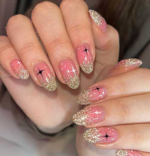 New Year’s nails feature gold glitter on the nail tips with black stars is the best New years nails ideas