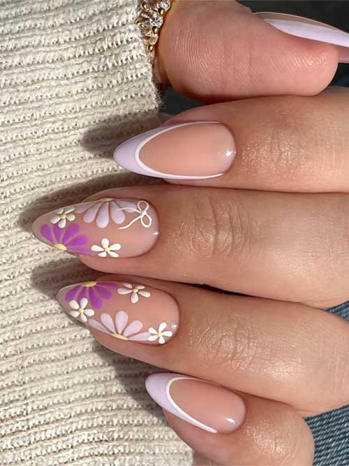 Delicate nude nails embellished with white and purple flowers, reflecting the fresh and lively essence of spring.