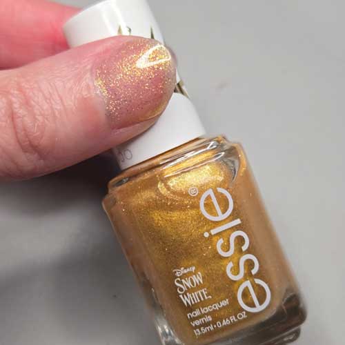 Multi-dimensional gold pixel pearl polish from essie x Disney's Snow White Collection, titled "Good Things Glow."